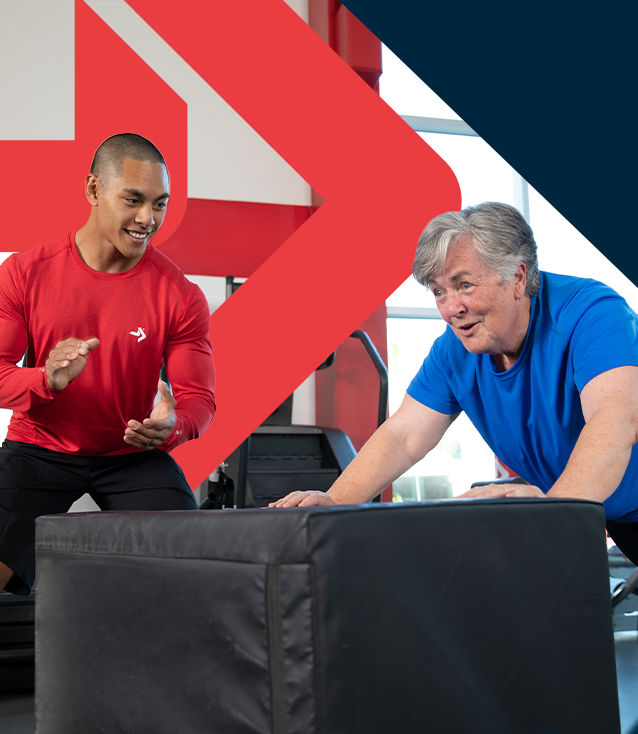 ACE Senior Fitness Specialist guiding older client through a supported push-up exercise to build strength safely